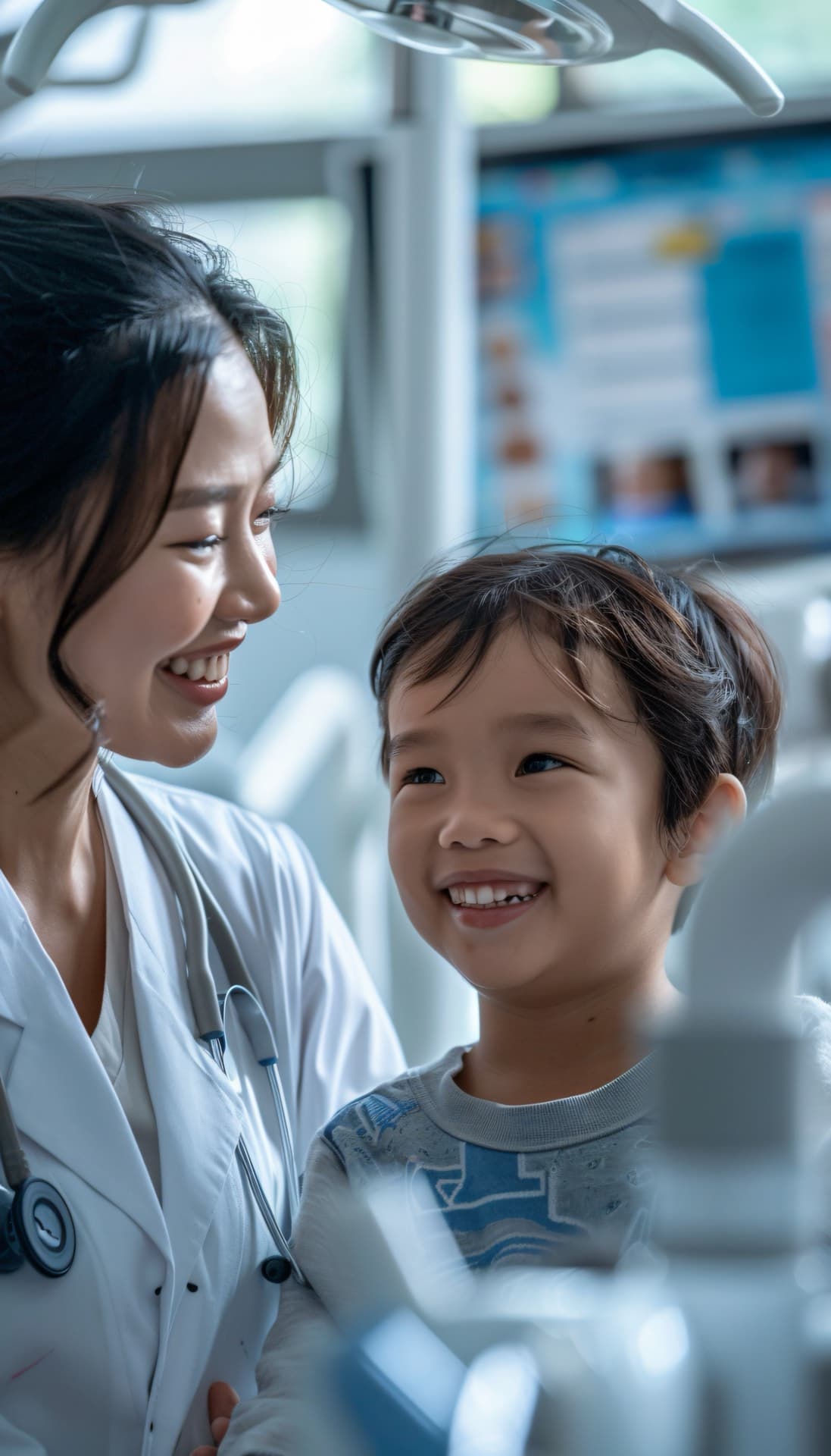Dentist standing beside a smiling child seated in a dental chair