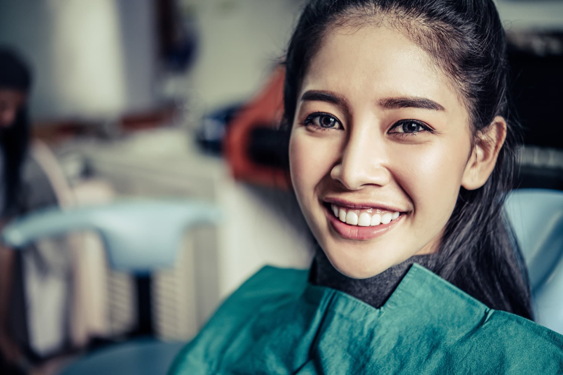Dentist examining a patient seated in a dental chair