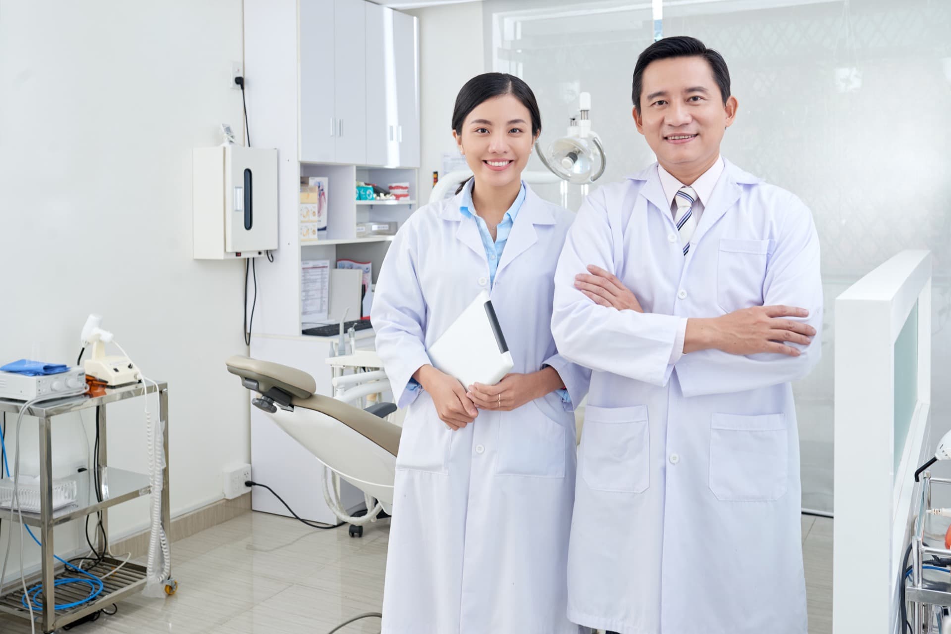 Two dental clinicians standing together in a treatment room